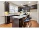 Stylish kitchen with dark cabinets, granite countertops, and stainless steel appliances at 5016 Whiteoak Se Pointe, Smyrna, GA 30080