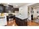 Well-appointed kitchen with dark cabinetry, stainless steel appliances, a granite island, and an open layout for modern living at 5016 Whiteoak Se Pointe, Smyrna, GA 30080