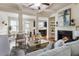 Spacious living room flows into the kitchen and dining area, featuring stylish furniture and a cozy fireplace for a welcoming feel at 5016 Whiteoak Se Pointe, Smyrna, GA 30080