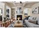 Inviting living room with a fireplace, built-in shelves, and coffered ceilings, perfect for relaxation and entertainment at 5016 Whiteoak Se Pointe, Smyrna, GA 30080