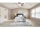Bright main bedroom featuring a ceiling fan, ensuite, and a large sunny window at 5016 Whiteoak Se Pointe, Smyrna, GA 30080