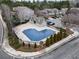 Community features a heart-shaped pool surrounded by brick columns and lush landscaping at 5016 Whiteoak Se Pointe, Smyrna, GA 30080