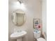 Bright powder room with pedestal sink, decorative mirror, and toilet at 5016 Whiteoak Se Pointe, Smyrna, GA 30080