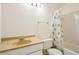A bathroom has a shower with a starfish shower curtain, toilet, and a vanity with a beige sink at 5638 River Heights Se Xing, Marietta, GA 30067