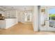 Open concept living space with wood floors, kitchen bar, and glass doors to the exterior at 5638 River Heights Se Xing, Marietta, GA 30067