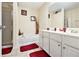 Well-lit bathroom featuring a dual vanity, tile floor, bathtub and shower at 780 Nehemiah Sw Ln # 37, Atlanta, GA 30331