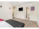 Neutral carpeted bedroom showing an entry to an ensuite bathroom, and TV at 780 Nehemiah Sw Ln # 37, Atlanta, GA 30331