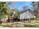 Backyard view showcasing a deck, steps, and the home's exterior with wooded surroundings at 90 Chimney Rise Ct, Stockbridge, GA 30281