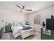 Neutral toned bedroom features a ceiling fan and window bringing in lots of natural light at 90 Chimney Rise Ct, Stockbridge, GA 30281
