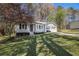 Charming single-story home featuring an attached two-car garage, a well-manicured lawn, and mature trees at 90 Chimney Rise Ct, Stockbridge, GA 30281