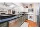 This updated kitchen features wood floors, white cabinets and stainless steel appliances at 90 Chimney Rise Ct, Stockbridge, GA 30281