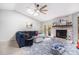 Bright living room with a brick fireplace, vaulted ceilings, and a comfortable blue sectional sofa at 90 Chimney Rise Ct, Stockbridge, GA 30281