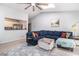 Living room featuring a comfortable blue sectional sofa and a view into the kitchen at 90 Chimney Rise Ct, Stockbridge, GA 30281