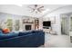 Bright living room with a brick fireplace, vaulted ceilings, and a comfortable blue sectional sofa at 90 Chimney Rise Ct, Stockbridge, GA 30281