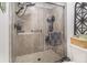 Tile shower with glass doors and a rainfall shower head with built-in shelves at 90 Chimney Rise Ct, Stockbridge, GA 30281