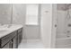 Bright bathroom featuring a shower, bathtub, window and vanity with dark wood cabinets at 350 Marble Springs Rd, Lilburn, GA 30047