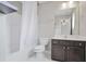 Well-lit bathroom featuring a bathtub with shower, toilet, vanity, and dark wood cabinets at 350 Marble Springs Rd, Lilburn, GA 30047