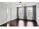 Bedroom with hardwood floors, two windows, neutral paint, and an ensuite bathroom with a walk-in closet at 350 Marble Springs Rd, Lilburn, GA 30047