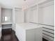 Walk-in closet featuring an island, vanity area, chandelier and custom shelving at 350 Marble Springs Rd, Lilburn, GA 30047