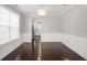 Dining room with modern chandelier, wood floors and white wainscoting detail at 350 Marble Springs Rd, Lilburn, GA 30047