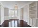 Bright dining room with hardwood floors, stylish chandelier, custom built-ins and large windows at 350 Marble Springs Rd, Lilburn, GA 30047