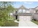 Charming two-story home with stone accents, two-car garage, and beautifully landscaped front yard at 350 Marble Springs Rd, Lilburn, GA 30047