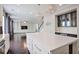 Modern kitchen featuring hardwood floors, large center island, stainless appliances, and adjacent living room at 350 Marble Springs Rd, Lilburn, GA 30047