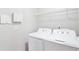 Bright laundry room with white washer and dryer and wire rack shelving overhead at 350 Marble Springs Rd, Lilburn, GA 30047