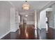 Spacious living room with hardwood floors, a decorative chandelier, and direct access to the kitchen at 350 Marble Springs Rd, Lilburn, GA 30047