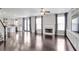 Bright living room featuring hardwood floors, a fireplace, and open access to kitchen at 350 Marble Springs Rd, Lilburn, GA 30047