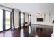 Open-concept living room boasting hardwood floors, custom built-ins, fireplace, and French door access to yard at 350 Marble Springs Rd, Lilburn, GA 30047