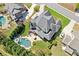 Stunning aerial view of a house with a luxurious backyard pool and meticulously maintained lawn at 968 Woodtrace Ln, Auburn, GA 30011
