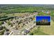 Beautiful aerial shot of homes in a neighborhood with lush greenery and a house inset at 968 Woodtrace Ln, Auburn, GA 30011