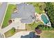 An aerial view of a house with a kidney-shaped pool, basketball court, and a well-manicured lawn at 968 Woodtrace Ln, Auburn, GA 30011