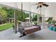 Relaxing back porch with a swing bed and views of the landscaped backyard at 968 Woodtrace Ln, Auburn, GA 30011