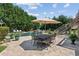 Lush backyard with a pool, patio dining set, and mature trees offering shade at 968 Woodtrace Ln, Auburn, GA 30011