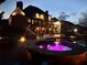 Backyard view featuring a pool, hot tub, deck and a lit outdoor living space at 968 Woodtrace Ln, Auburn, GA 30011