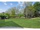 Lush, well-maintained backyard featuring a green lawn with tasteful garden, shrub, and tree borders at 968 Woodtrace Ln, Auburn, GA 30011