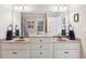 Bright bathroom with double sinks, large mirrors, and plenty of cabinet space at 968 Woodtrace Ln, Auburn, GA 30011