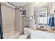 Cozy bathroom showcasing a tub, shower, vanity, toilet, and decorative shelves at 968 Woodtrace Ln, Auburn, GA 30011