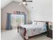 Comfortable bedroom with vaulted ceiling, large window, and shiplap accent wall at 968 Woodtrace Ln, Auburn, GA 30011