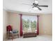 A bright bedroom featuring a window with a great view at 968 Woodtrace Ln, Auburn, GA 30011