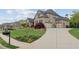 View of an extended driveway leading to a spacious two-car garage with well-maintained landscaping at 968 Woodtrace Ln, Auburn, GA 30011