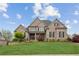 Impressive brick home with manicured lawn, beautiful landscaping, and a welcoming front porch at 968 Woodtrace Ln, Auburn, GA 30011
