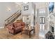 Open foyer with hardwood floors, staircase, and a view of the front door and chandelier at 968 Woodtrace Ln, Auburn, GA 30011