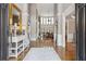 Grand foyer with high ceilings, hardwood floors, elegant decor, and a view into the living room at 968 Woodtrace Ln, Auburn, GA 30011