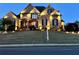 Beautifully lit front exterior with landscaped yard showcasing a well-maintained brick home at 968 Woodtrace Ln, Auburn, GA 30011