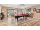 Spacious game room with a pool table, ceiling fan, and windows providing natural light at 968 Woodtrace Ln, Auburn, GA 30011