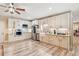 Bright kitchen with white cabinets, stainless steel appliances, and wood-look flooring at 968 Woodtrace Ln, Auburn, GA 30011