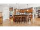 Kitchen with wooden cabinets, granite countertops, stainless steel appliances, and a large island with bar seating at 968 Woodtrace Ln, Auburn, GA 30011